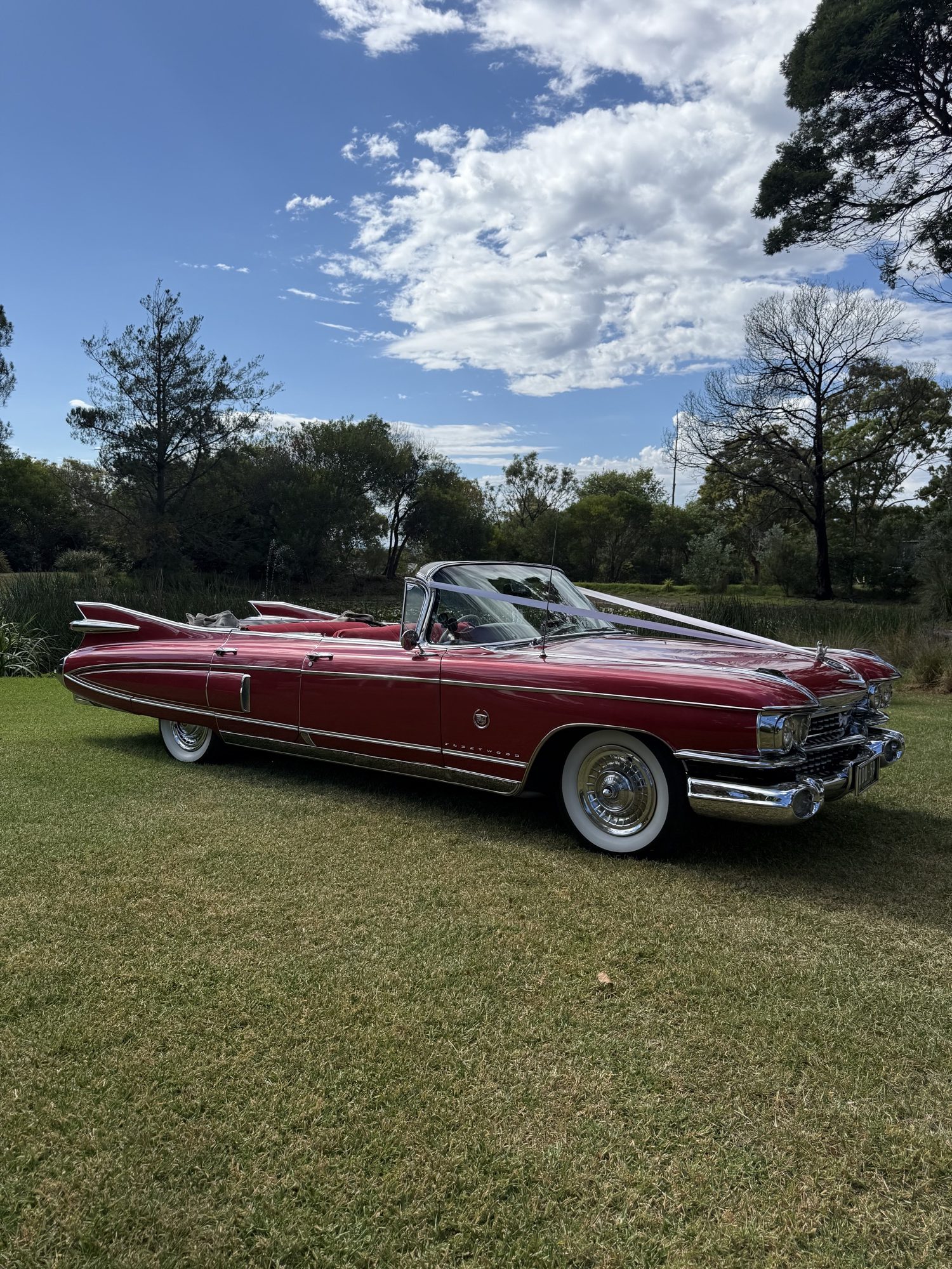 Rosie the rose pink Cadillac convertible wedding car at a country estate