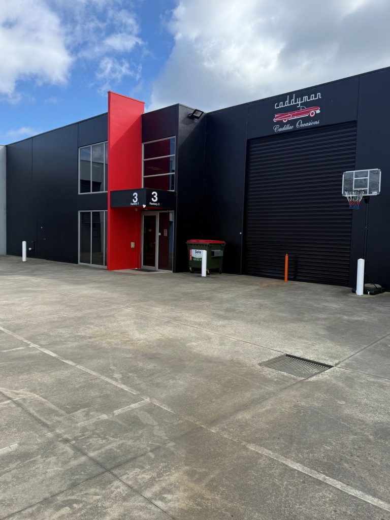 Front of the Caddyman showroom at 2/3 Duiker Court, Langwarrin, black building with red feature panel and Caddyman signage