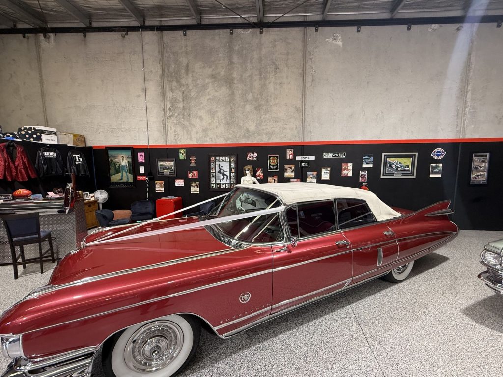 Side view of Rosie, the pink 1959 Cadillac convertible, inside the Caddyman showroom at 2/3 Duiker Court, Langwarrin