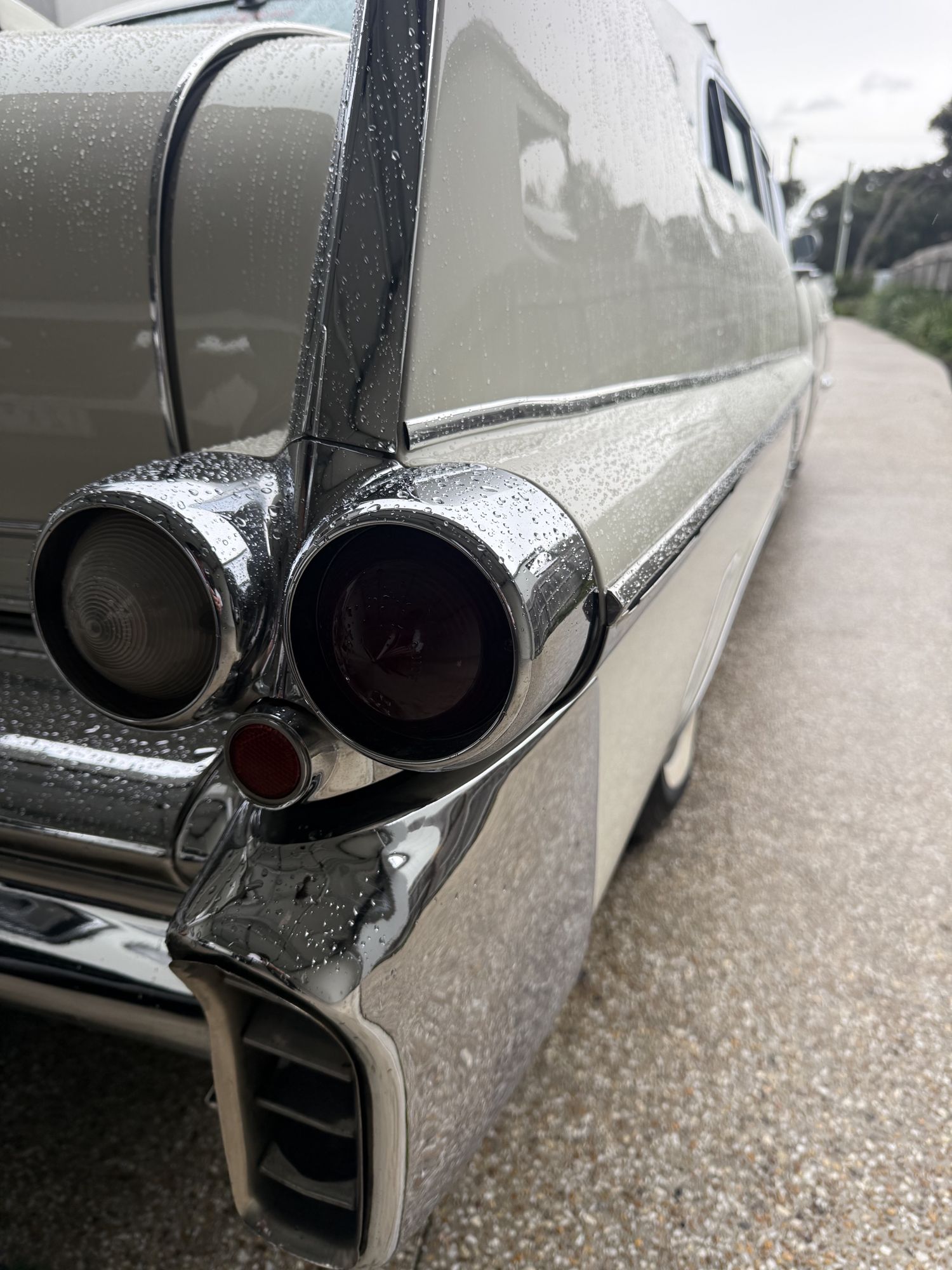 Tail fin, tail lights and chrome bumper detail on The Duchess, Caddyman's white 1957 Cadillac Series 75 wedding limousine