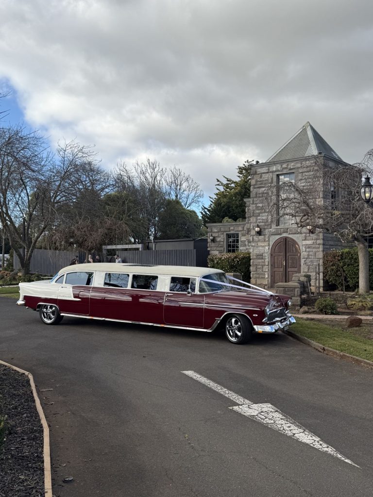 The Prince of Belair, Caddyman's maroon 1955 Chevrolet Bel Air stretch limousine, outside a stone church